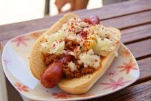 Hot dog with chili and onions on a plate